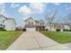 Two-story house with brick front, two-car garage, and driveway, on a landscaped lot at 2131 Ashley Glen Way, Indian Land, SC 29707