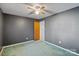 Simple bedroom with ceiling fan and door to hallway at 214 Costner Dr, Bessemer City, NC 28016