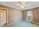 Bedroom with ceiling fan, window curtains, and door to another room at 214 Costner Dr, Bessemer City, NC 28016