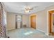 Bedroom with ceiling fan, window curtains, and door to hallway at 214 Costner Dr, Bessemer City, NC 28016