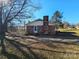 Brick house side view, showing a side entrance and driveway at 214 Costner Dr, Bessemer City, NC 28016