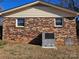 Rear view of the house showing the HVAC unit and brick exterior at 214 Costner Dr, Bessemer City, NC 28016