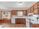 Kitchen with wood cabinets, white appliances, and window view at 214 Costner Dr, Bessemer City, NC 28016