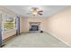 Living room featuring a brick fireplace and ceiling fan at 214 Costner Dr, Bessemer City, NC 28016