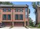 Brick front exterior of a three-story townhome with a two-car garage at 2549 Vail Ave, Charlotte, NC 28207