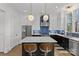 Modern kitchen with white and dark cabinets, quartz countertops and island with seating at 2549 Vail Ave, Charlotte, NC 28207