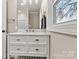 Updated bathroom with white vanity, quartz countertop and window at 2829 1St Nw Ave, Hickory, NC 28601