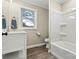 Clean bathroom with white bathtub, vanity, and wood-look floor at 2829 1St Nw Ave, Hickory, NC 28601