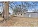 Tan house exterior with detached garage and mature tree at 2829 1St Nw Ave, Hickory, NC 28601