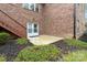 Brick home backyard featuring an entrance to the basement, patio, wooden stairs, and garden at 2865 Scarborough Ct, Gastonia, NC 28054