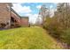 Brick home with stairs leading to the backyard, which features a well-maintained lawn at 2865 Scarborough Ct, Gastonia, NC 28054