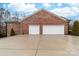 Spacious three-car garage showcasing ample parking and a well-maintained brick exterior, providing both functionality and style at 2865 Scarborough Ct, Gastonia, NC 28054