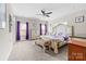 Spacious main bedroom featuring a decorative bed frame, carpet flooring, and natural lighting at 2865 Scarborough Ct, Gastonia, NC 28054