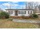 Charming single-story home with white siding, brown shutters, and a walkway leading to the front door at 2907 1St Nw Ave, Hickory, NC 28601