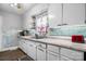 Kitchen sink with white cabinets and brick tile backsplash at 2907 1St Nw Ave, Hickory, NC 28601