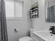 Bright bathroom with a modern sink and faucet, toilet, and shower with patterned curtains at 3021 Botany St, Charlotte, NC 28216