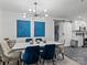 Dining room with modern chandelier and stylish seating, adjacent to a kitchen with white cabinets at 3021 Botany St, Charlotte, NC 28216