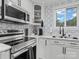 Well-lit kitchen featuring modern appliances, white cabinetry, and stylish backsplash and countertops at 3021 Botany St, Charlotte, NC 28216