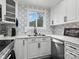 Bright kitchen with white cabinets, stainless steel appliances, and stylish backsplash tile at 3021 Botany St, Charlotte, NC 28216