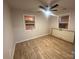 Well-lit bedroom with new flooring and ceiling fan at 3027 Remington St, Charlotte, NC 28216