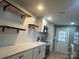 Modern kitchen featuring stainless steel appliances, floating shelves, and updated countertops at 3027 Remington St, Charlotte, NC 28216