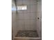 Contemporary shower with marble-look tiles and pebble floor at 3027 Remington St, Charlotte, NC 28216