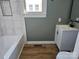 Updated bathroom with gray walls, white vanity, and a marble shower at 330 West Blvd, Charlotte, NC 28203