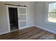 Bright bedroom with hardwood floors and barn door leading to bathroom at 330 West Blvd, Charlotte, NC 28203