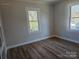 Simple bedroom with hardwood floors and large windows at 330 West Blvd, Charlotte, NC 28203