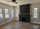 Spacious living room with a brick fireplace and hardwood floors at 330 West Blvd, Charlotte, NC 28203