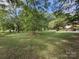 Spacious backyard with lush green grass and mature trees at 3333 Audrey Dr, Gastonia, NC 28054