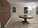 Round table in a sunroom with brick wall at 3333 Audrey Dr, Gastonia, NC 28054