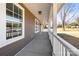 Long front porch with white railings and light fixtures at 344 Luther Scronce Rd, Vale, NC 28168