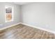 Spacious bedroom with wood-look floors and a large window at 413 Peach St, Kannapolis, NC 28083