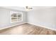 Bright bedroom with wood-look floors and ceiling fan at 413 Peach St, Kannapolis, NC 28083