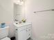 Modern bathroom with white vanity, toilet and a mirror at 414 W Tremont Ave, Charlotte, NC 28203