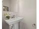 Guest bathroom with pedestal sink and decorative flowers at 414 W Tremont Ave, Charlotte, NC 28203