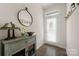 Bright entryway with a mirror, console table, and coat rack at 414 W Tremont Ave, Charlotte, NC 28203