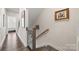 Upstairs hallway with stairs and a view into a bedroom at 414 W Tremont Ave, Charlotte, NC 28203