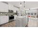 Modern kitchen with white cabinets, stainless steel appliances, and island at 414 W Tremont Ave, Charlotte, NC 28203