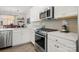 Bright kitchen with stainless steel appliances and white cabinets at 414 W Tremont Ave, Charlotte, NC 28203