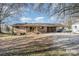 Backyard view with large shade trees, storage shed, and gravel driveway at 48780 N Us 52 Hwy, Richfield, NC 28137