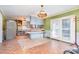 View of kitchen featuring a peninsula and eat in breakfast area next to glass doors leading to back deck at 48780 N Us 52 Hwy, Richfield, NC 28137