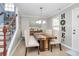 Bright dining room featuring a rustic wood table and stylish light fixture at 4944 Cornelia Dr, Charlotte, NC 28269