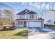 Two-story house with white and dark gray siding, a white garage door, and a small front porch at 4944 Cornelia Dr, Charlotte, NC 28269