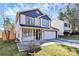 Two-story house with white and dark blue siding, a white garage door, and a small front porch at 4944 Cornelia Dr, Charlotte, NC 28269