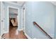 Upstairs hallway with light blue walls and hardwood floors at 4944 Cornelia Dr, Charlotte, NC 28269