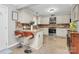 Modern kitchen with island seating, white cabinets, and stainless steel appliances at 4944 Cornelia Dr, Charlotte, NC 28269