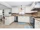 Modern kitchen with island seating, white cabinets, and stainless steel appliances at 4944 Cornelia Dr, Charlotte, NC 28269