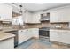 Modern kitchen with white cabinets, stainless steel appliances, and granite counters at 4944 Cornelia Dr, Charlotte, NC 28269